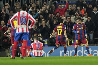 Lionel Messi celebrates with Pedro after scoring for Barcelona against Atletico Madrid in 2011.