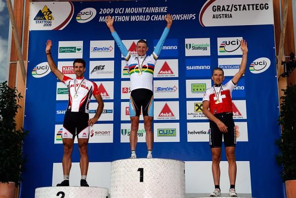 World champion Roel Paulissen (Belgium) celebrates on the podium with Alban Lakata (Austria), left, and Christoph Sauser (Switzerland), right.