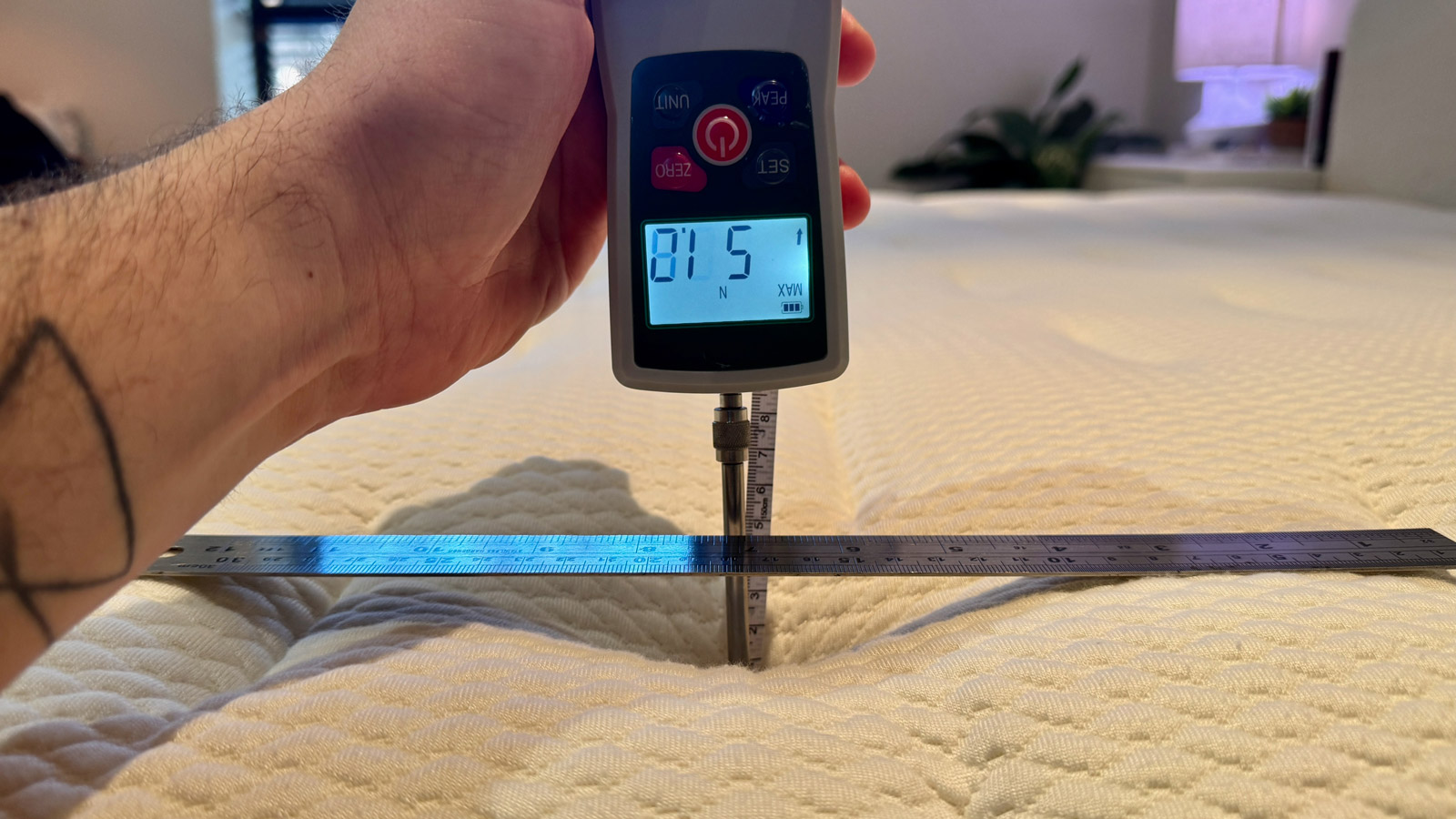 A digital force gauge pressing down on the Yinahla Premier Luxe mattress