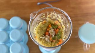 Nutribullet Baby blender filled with peas, carrots and cauiflower
