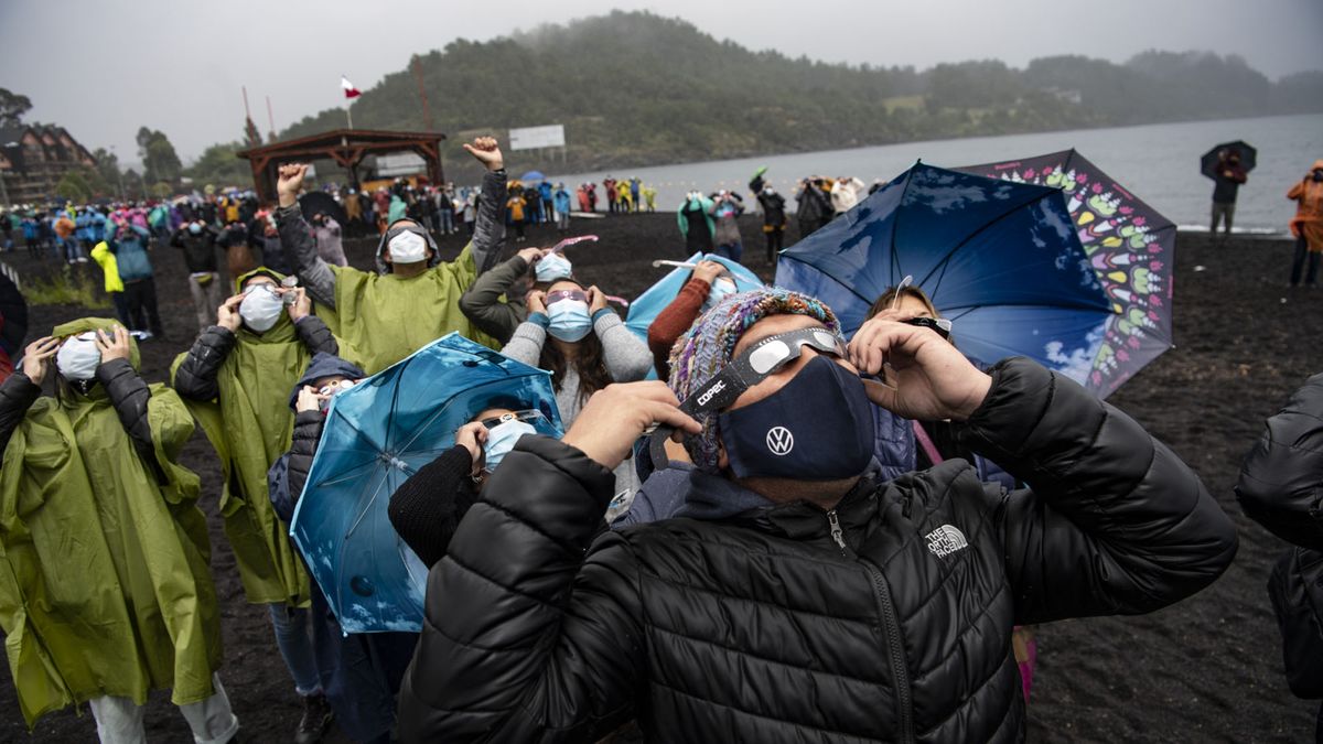 People watch the total solar eclipse on the banks of Villarrica lake in Puc&oacute;n, southern Chile, on Dec. 14, 2020.