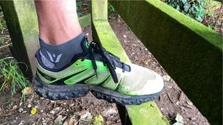Man wearing Swiftwick Flite XT Zero Tab trail running socks and sneakers / trainers