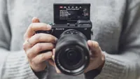 The Sony Alpha A6400 being held in two hands