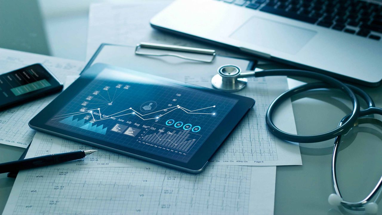 tablet with charts and stethoscope