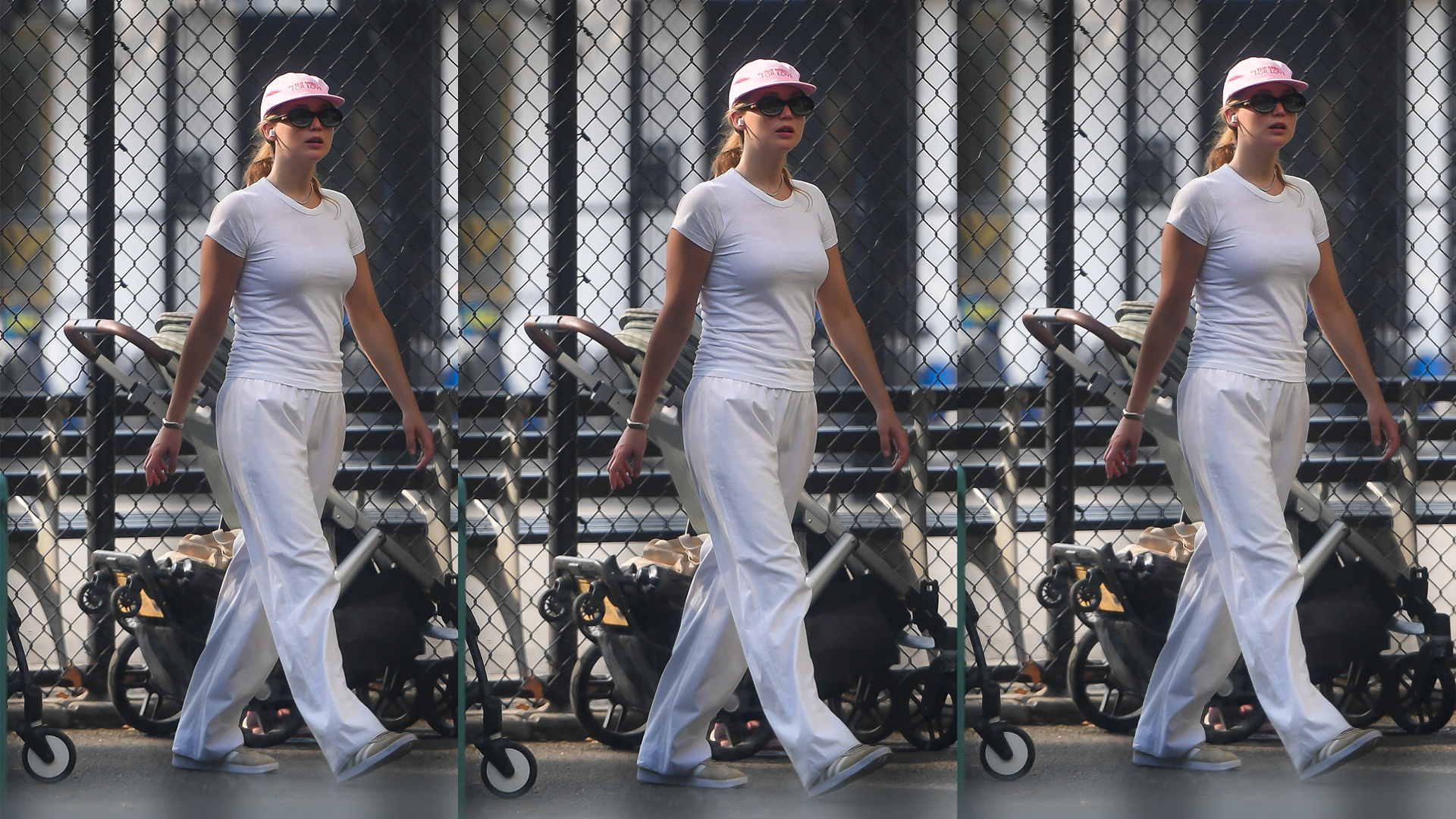 Jennifer Lawrence wears white top and bottoms with gray Adidas and a baseball cap. 