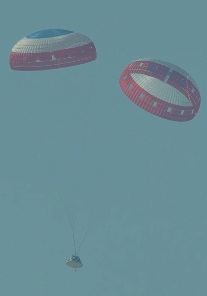 a cone-shaped spacecraft landing under two parachutes