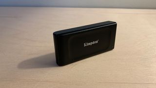 Kingston XS1000 SSD on a wooden desk