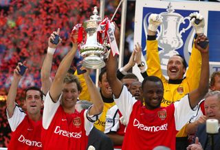 Tony Adams lifted the FA Cup as Arsenal completed the double with victory in Cardiff.
