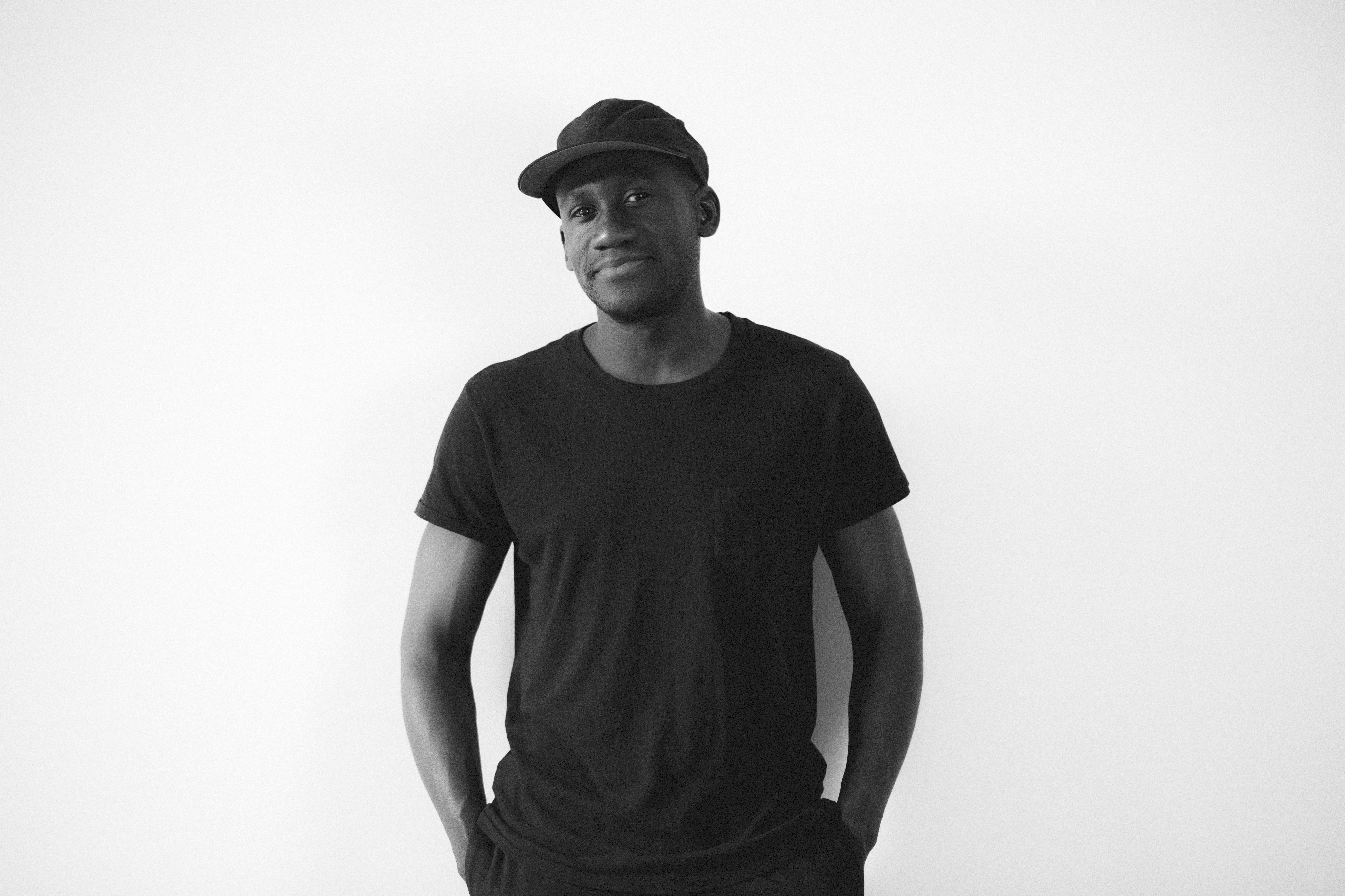 man in a black t-shirt and baseball cap