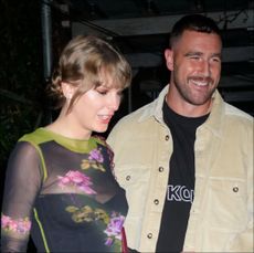 Taylor Swift and Travis Kelce share a New Year's Eve kiss. 