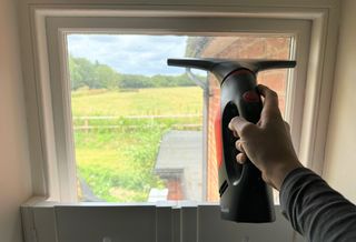 The Windomatic window vacuum being used on a window