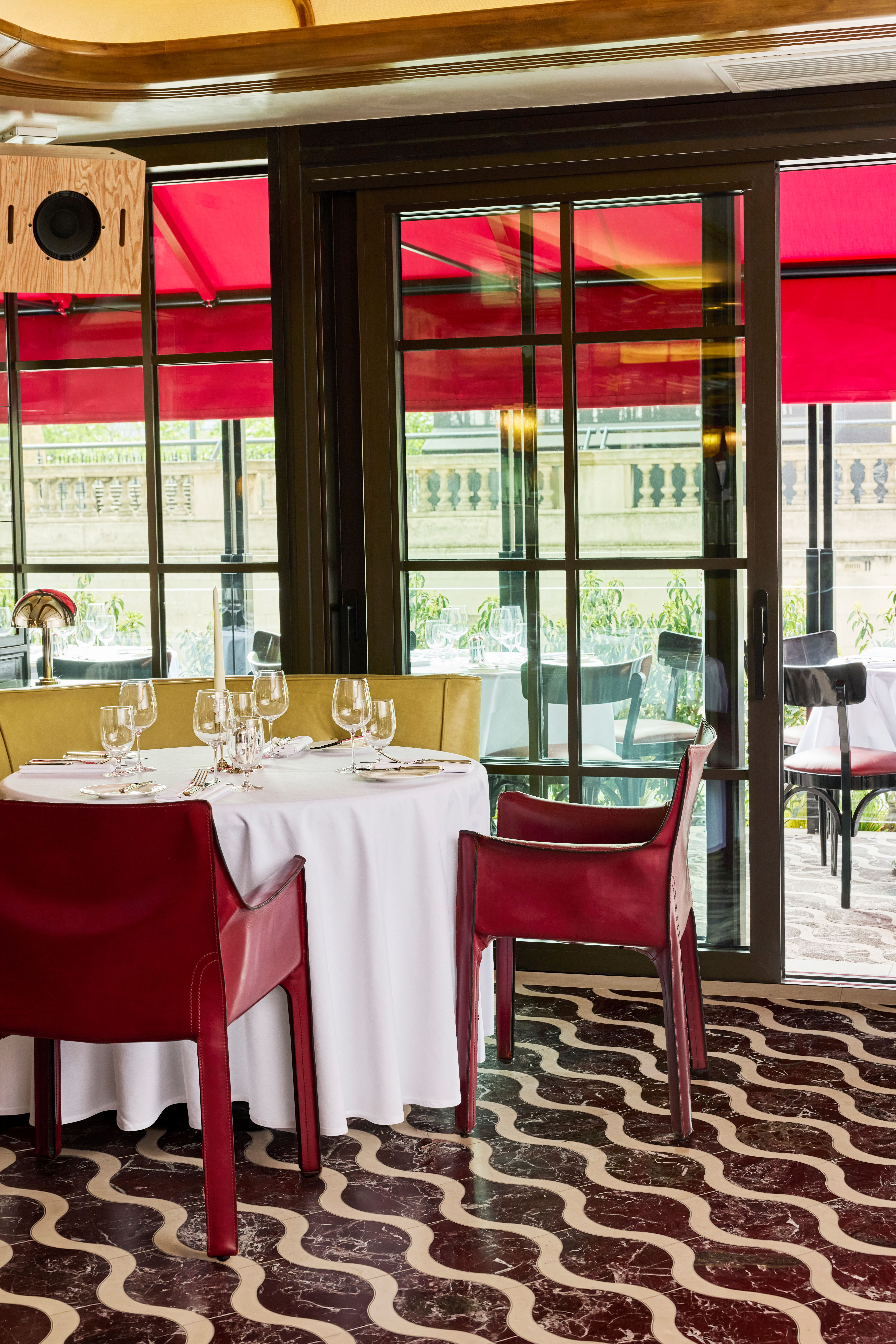Brasserie-style dining room with warm tones, river views and an open, airy atmosphere