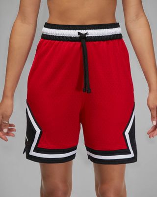 model wears red and black basketball shorts