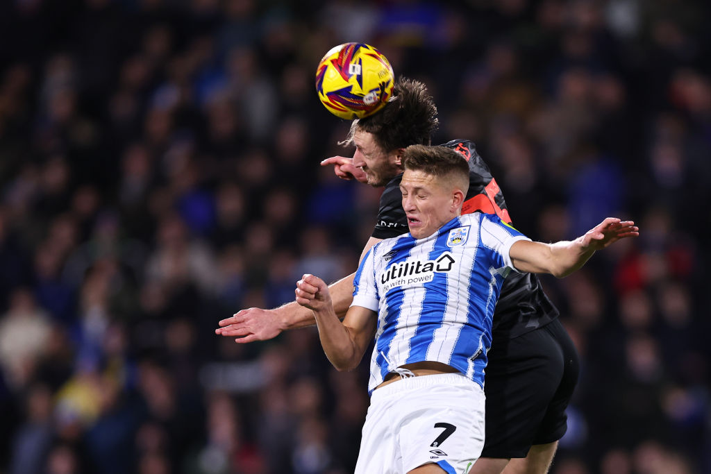 Callum Marshall challenges for a header