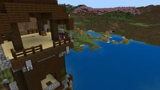Minecraft seeds - a pillager outpost on the lake looks ominously on a nearby village