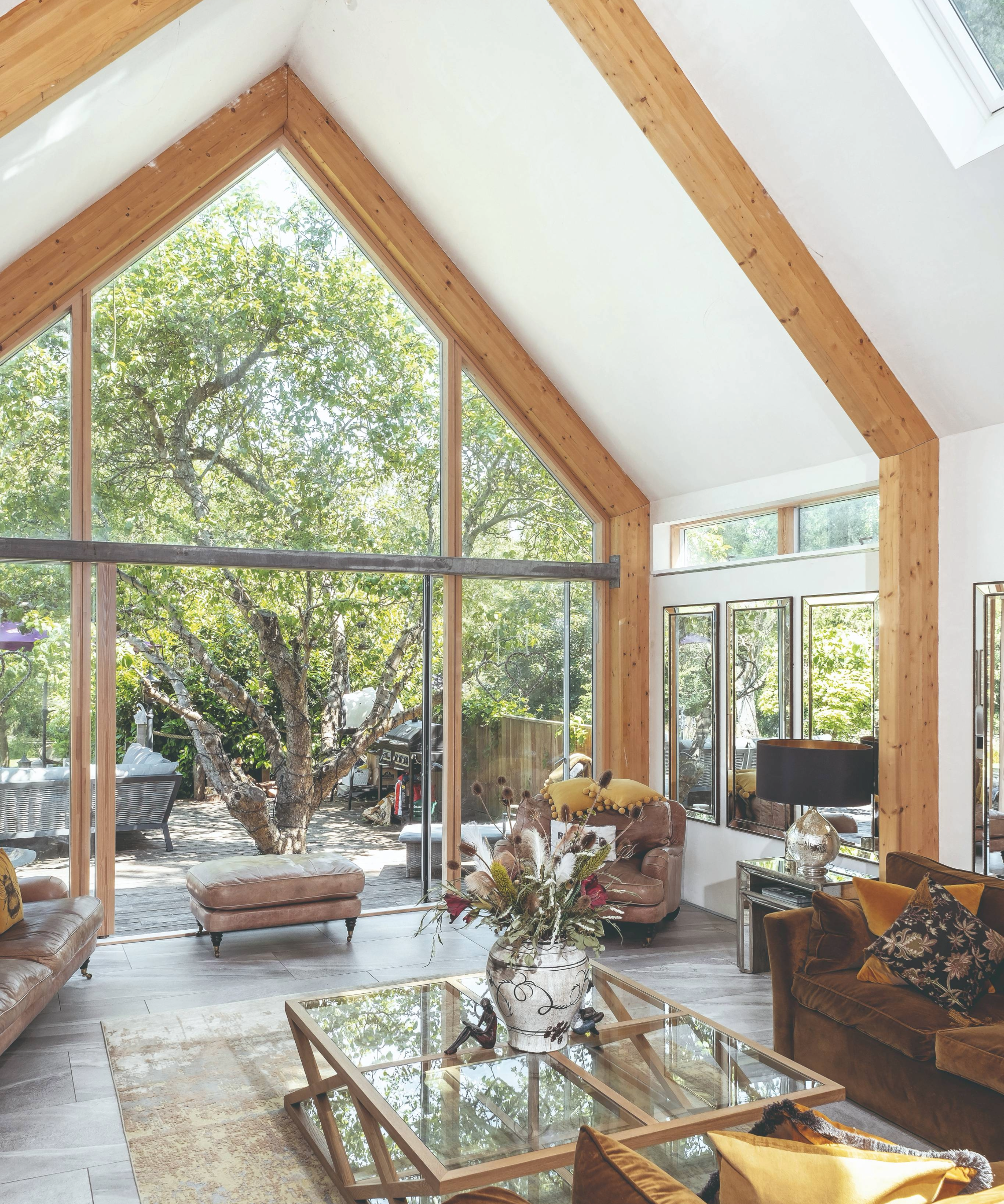Living room with vaulted ceiling and view onto garden
