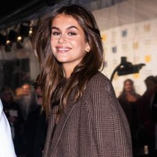 Kaia Gerber wore white chunky sneakers from On with a matching gym bag
