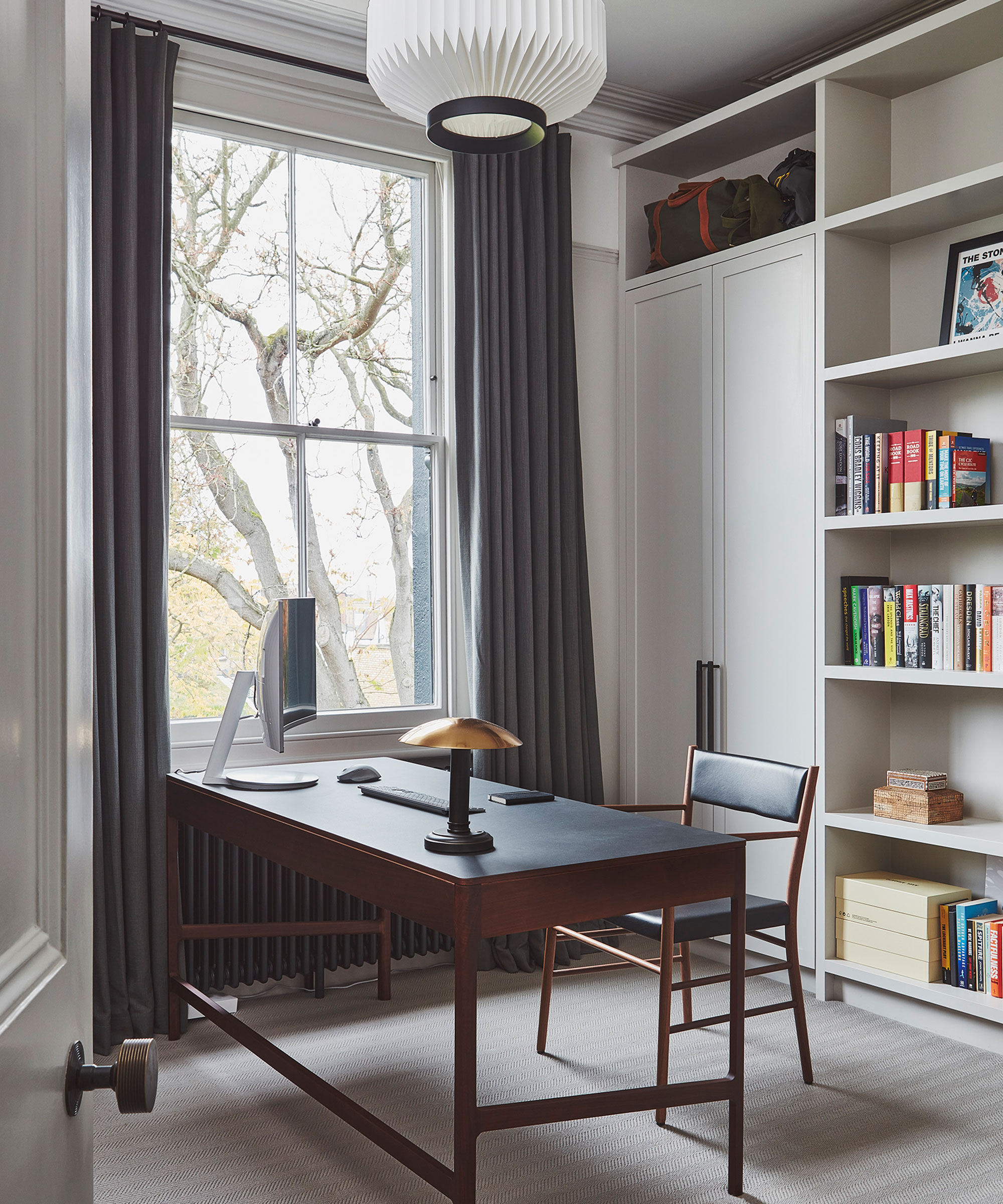 simple home office with black and wooden design and sash window