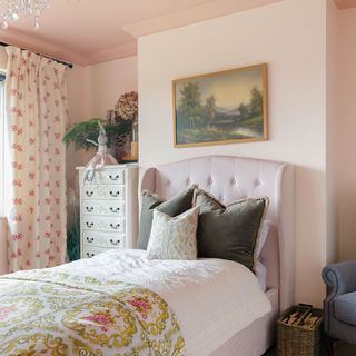 pink girls bedroom with upholstered bed