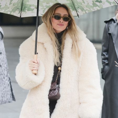 Hilary Duff wearing a cream fur coat in London
