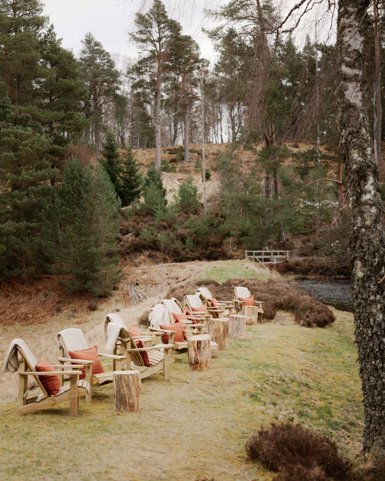 Chairs along a Scottish riverbank