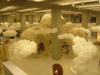 Globular "rooms" sit amongst clouds of white balloons