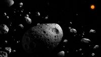 An artist’s illustration of the massive, fast-spinning asteroid 2025 MN45, discovered in the first data from the Vera C. Rubin Observatory. Dimpled gray rocks against the black background of space.