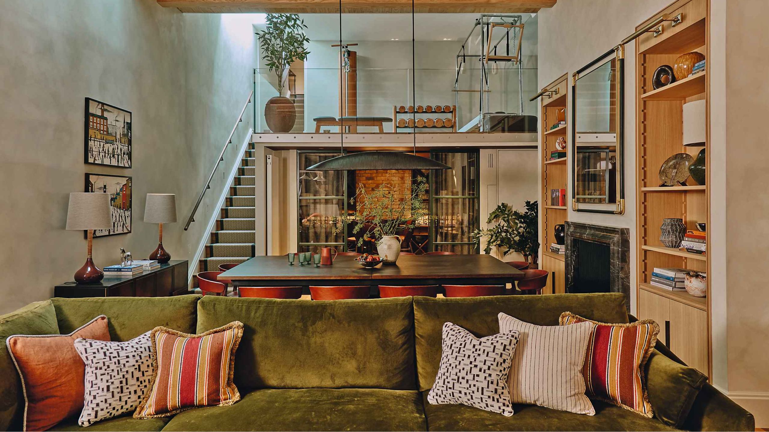 a large mid century inspired basement room with a gym dining and sitting area