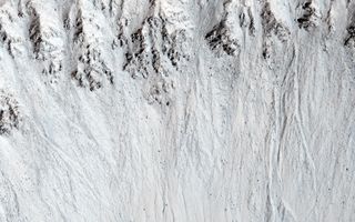 Recurring slope lineae are shown in Raga Crater. These are likely briny water features that disappear and reappear every Martian year, and scientists regularly study where they are to see yearly changes. Image taken by the Mars Reconnaissance Orbiter's HiRISE camera.
