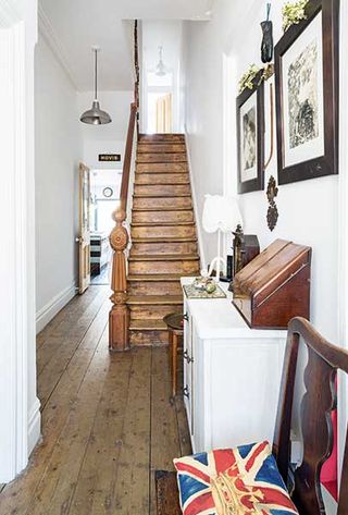 White hallway in Victorian Terrace with original wooden stairs