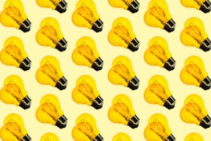 lots of yellow lightbulbs in a row on a yellow background