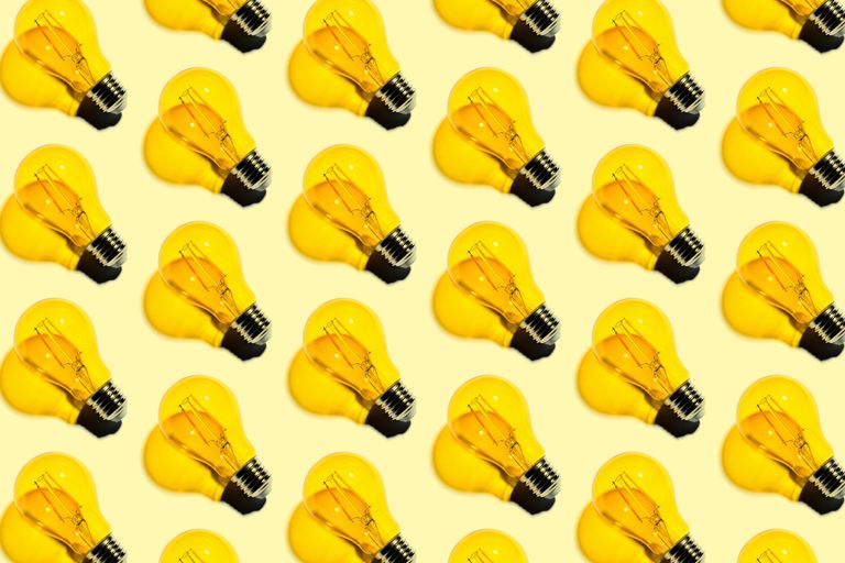 lots of yellow lightbulbs in a row on a yellow background