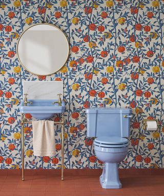 Bathroom with blue fixtures and patterned wallpaper