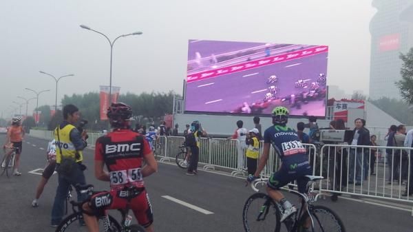 The last riders to come in watch the sprint on the big screen.