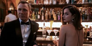 Daniel Craig and Ana de Armas as James Bond and Paloma at a bar in No Time To Die