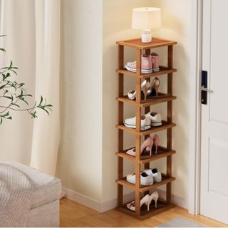 a wooden vertical shoe rack with a little table on top