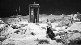 a police box in a strange landscape with a time traveler in the foreground