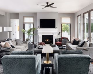 Large gray living room, seating arranged around fireplace