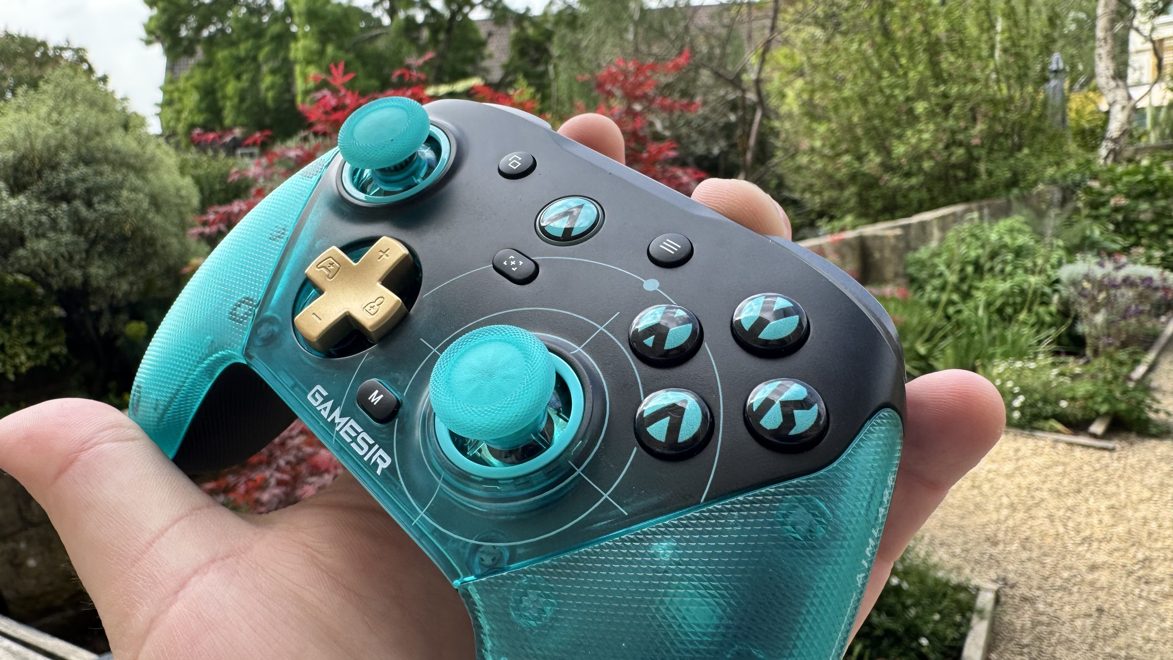 The GameSir G7 Pro 8K Aimlabs Edition in a hand outside, from the right