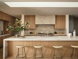 a neutral kitchen with a stone clad hood