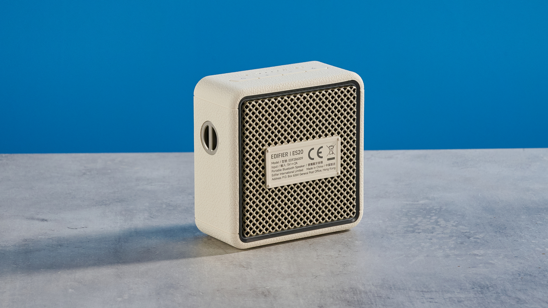 Edifier ES20 Bluetooth speaker in ivory colorway photographed on a blue background
