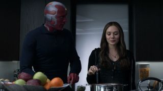 Vision (Paul Bettany) and Wanda Maximoff (Elizabeth Olsen) cook on WandaVision