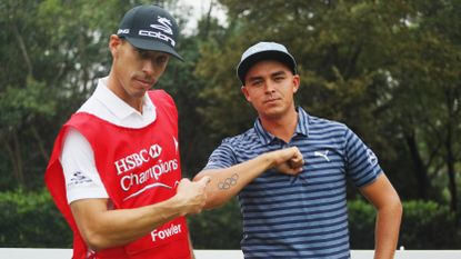 Joe Skovron, caddie for Rickie Fowler of the United States, points to his Olympic Rings tattoo during a practice round prior to the start of the WGC - HSBC Champions at the Sheshan International Golf Club on October 26, 2016