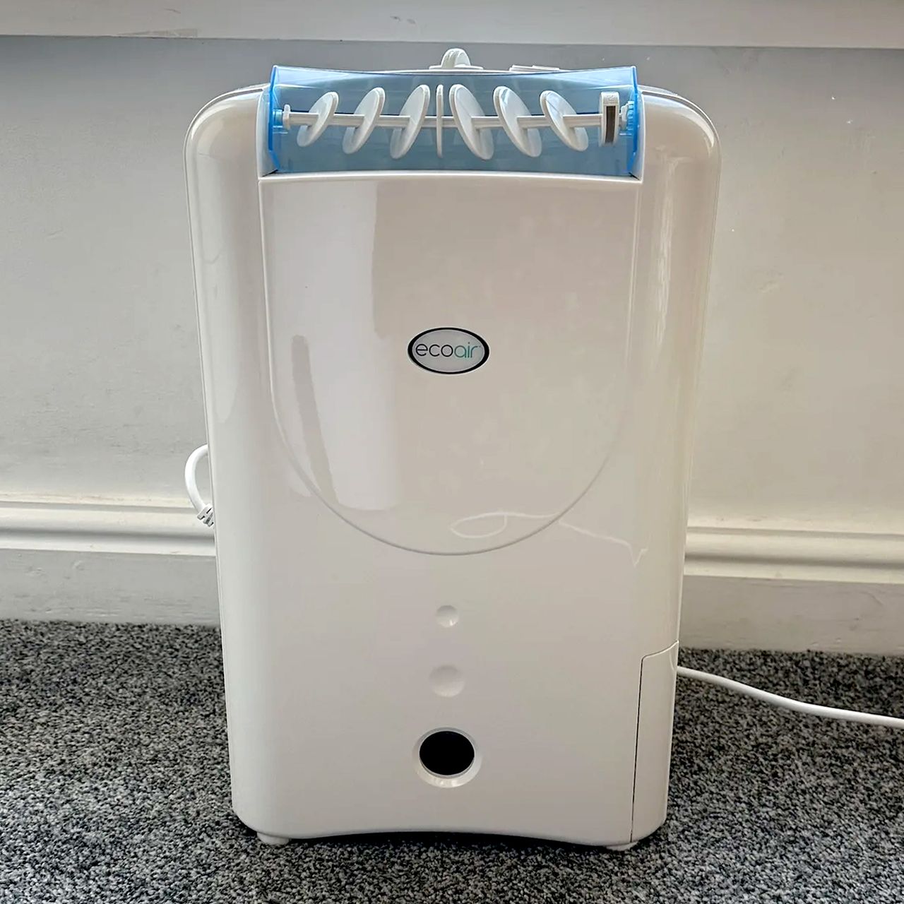 The EcoAir DD1 Simple MK3 Dehumidifier on a grey carpet