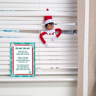 Elf on the Shelf hiding in the blinds