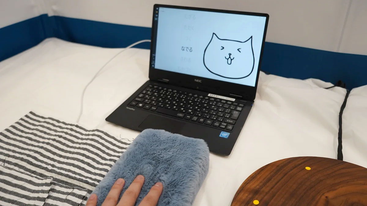 Japanese firm demos tech that makes any object a capacitive touch surface — stuffed cat on display, works with wood, ceramic, and plasterboard, too