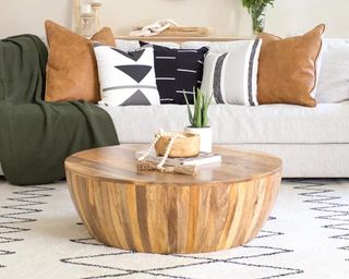 A round wooden coffee table in boho living room