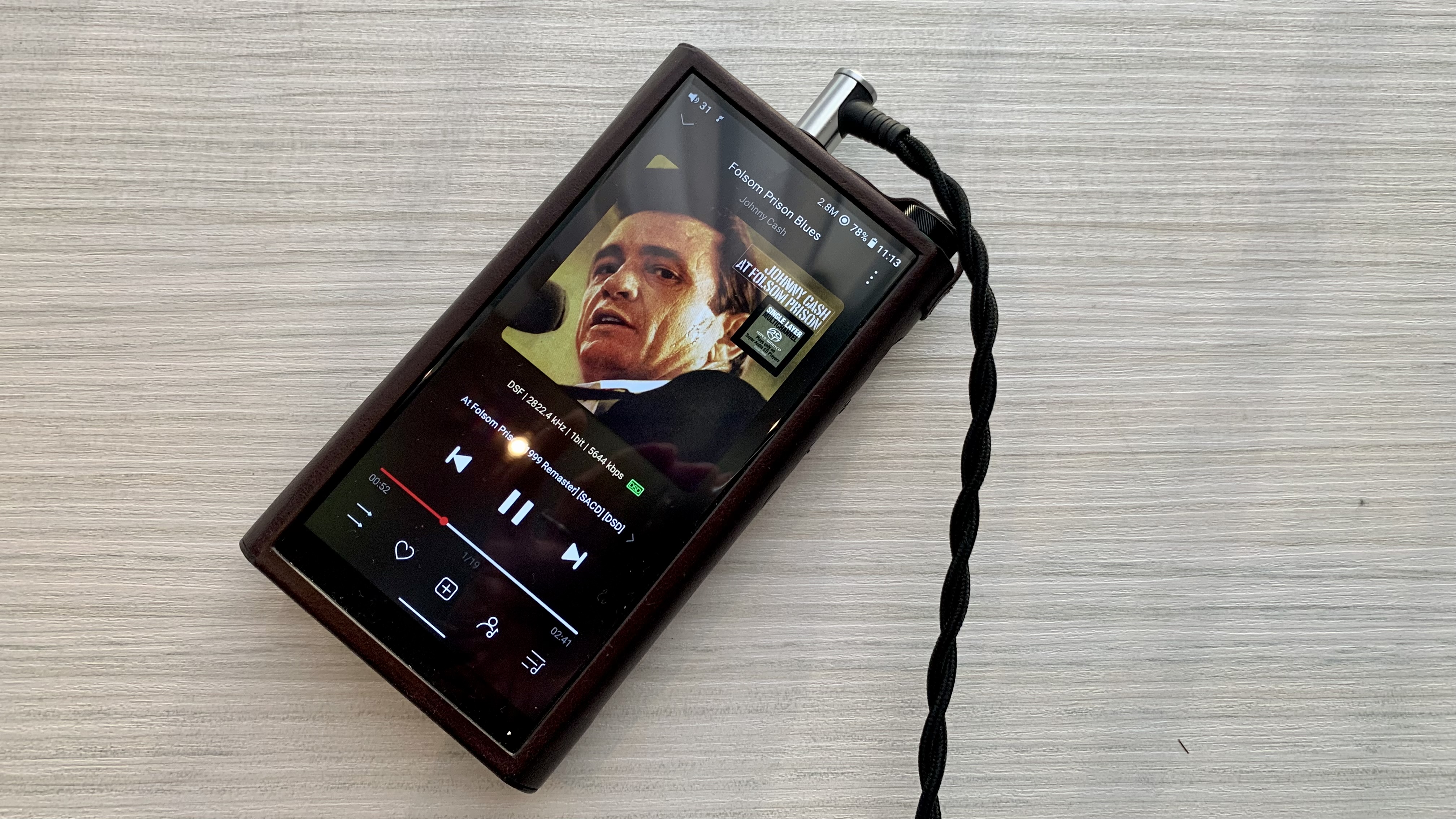 FiiO M15S with Johnny Cash on the screen, on a coffee table