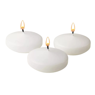 A set of three lit round floating candles