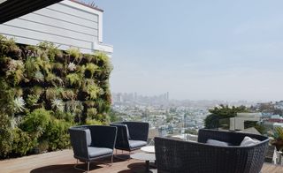 A terrace with a lush living wall
